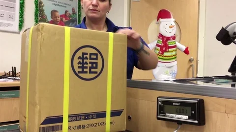 Motion of man taking parcel at post office inside shoppers drug mart Stock Footage 70859545