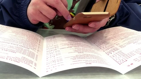 Motion of man using cellphone and checking price at menu Stock Footage 70998598