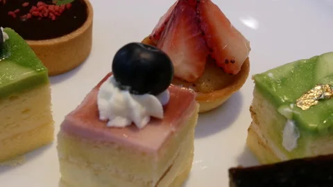 Motion of mini cake on table inside restaurant with 4k resolution. Video stock 97078434