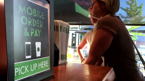 Motion of mobile order and pay sign beside that people waiting their coffee Stock Footage 67466978