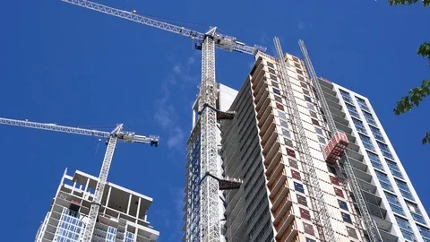 Motion of modern high rise building with construction crane 4k resolution Video stock 78996474