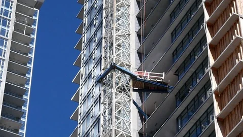 Motion of modern high rise building with construction crane 4k resolution Stock Footage 79087481
