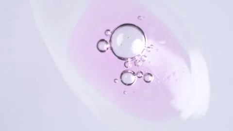 Motion of molecule bubbles in a cosmetic serum, macro. Pink transparent cos.. Stock Footage 269026431