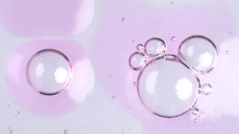 Motion of molecule bubbles in a cosmetic serum, macro. Pink transparent cos.. Stock Footage 269041961