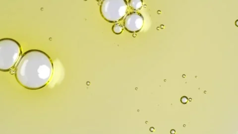 Motion of molecule bubbles in a cosmetic serum, macro. Transparent yellow c.. Stock Footage 271130997