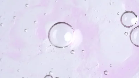 Motion of molecule bubbles in a cosmetic serum, macro. Pink transparent cos.. Stock Footage 271131057