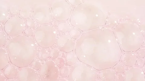 Motion of molecule bubbles in a cosmetic serum, macro. Clear pink cosmetic .. Stock Footage 297249279