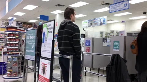 Motion of mother bring son having flu shot at pharmacy section Stock Footage 69042451