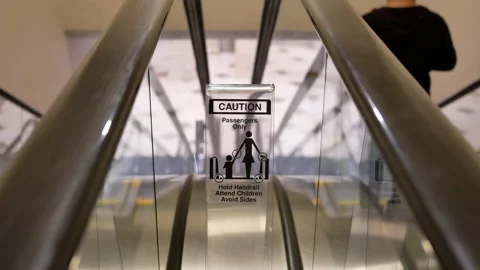 Motion of moving empty escalator and caution sign inside shopping mall Video stock 103446458