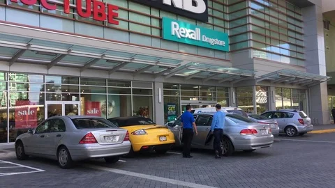 Motion of multiple store front with people and car passing by store Stock Footage 79051524
