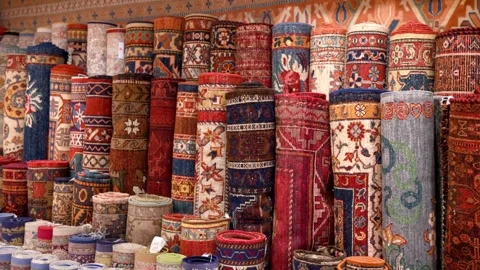 A motion of neatly rolled up carpets and rugs showcasing a variety of vibra.. Stock Footage 339655217