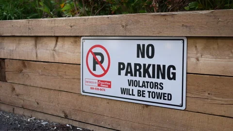 Motion of no parking violators will be towed sign on wall with 4k resolution Stock Footage 139246786