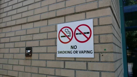 Motion of no smoking area including electronic cigarettes sign on wall Stock Footage 94723165