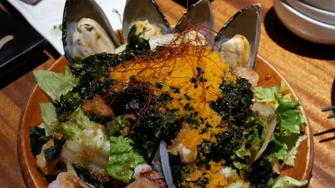 Motion of oyster seafood salad on table inside Japanese restaurant Stock Footage 96781802