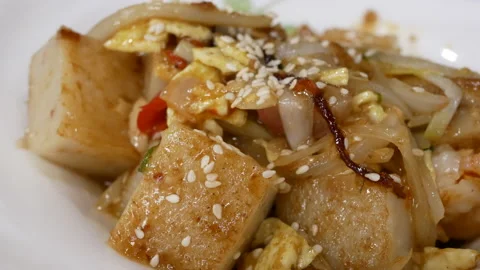 Motion of pan fried turnip cake dim sum inside Chinese restaurant Video stock 102593242