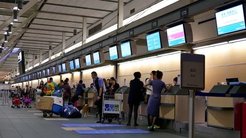 Motion of passengers with luggage at check in area inside YVR airport Stock Footage 81084089