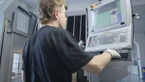 Motion Past Young Worker at Machine Tool Control Panel Stock Footage 78640002