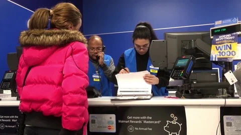 Motion of people asking about lost item and worker checking lost log Stock Footage 83717441