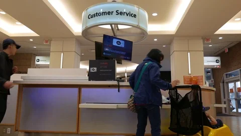 Motion of people asking question at customer service counter Stock Footage 75562638