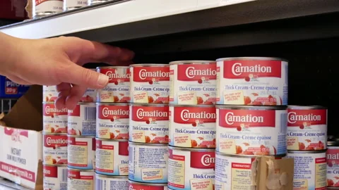 Motion of people buying Carnation thick cream inside price smart foods store Stock Footage 108013961