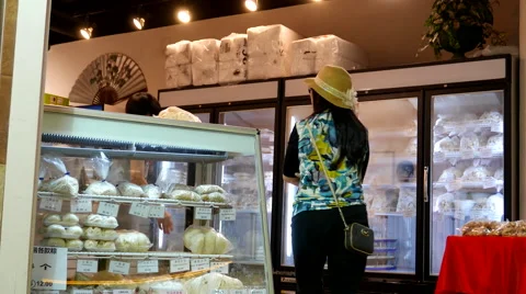 Motion of people buying dumpling and bread inside dim sum world store Stock Footage 65798552