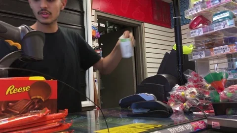 Motion of people buying lottery ticket inside esso gas station convenient store Stock Footage 79586176