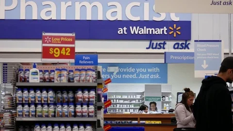 Motion of people buying medicine at pharmacy section inside Walmart store Stock Footage 80478317