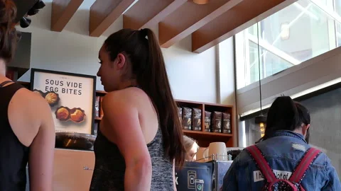 Motion of people chatting while waiting for coffee inside Starbucks store 스톡 동영상 90213896