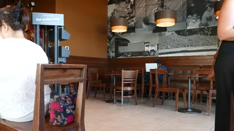 Motion of people drinking coffee inside coffee shop with 4k resolution. 動画素材 127894090