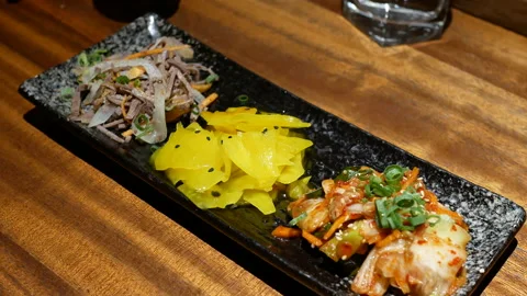 Motion of people eating appetizers on table inside Japanese restaurant Video stock 96820403