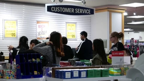 Motion of people line up for paying item at customer service counter Stock Footage 80298575