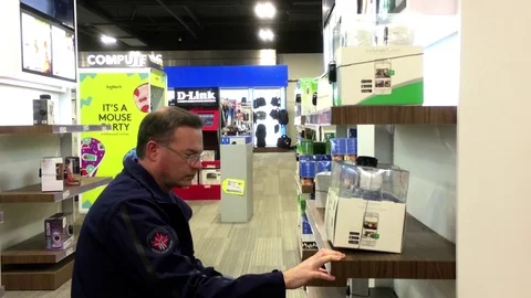 Motion of people looking new security camera inside store Stock Footage 71154523