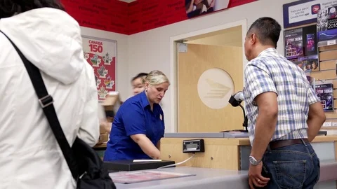 Motion of people mailing parcel at post office inside shopper drug mart store Stock Footage 76928009