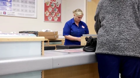 Motion of people mailing parcel at post office inside shopper drug mart store Stock Footage 76941091