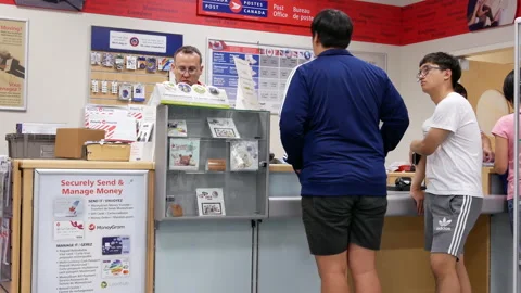 The motion of people mailing their parcels inside a shopper drug mart Video stock 213176904