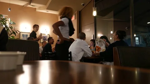 Motion of people ordering foods inside Denny's restaurant, focus on people Stock Footage 125679335