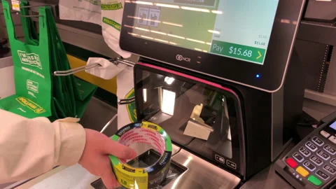 Motion of people paying items at self check out counter inside Dollar store Stock Footage 137627269