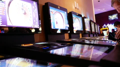 Motion of people playing casino roulette on machine Stock Footage 86536682