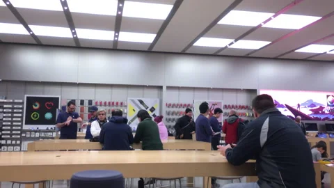 Motion of people playing iphone inside Apple store Video stock 108282898