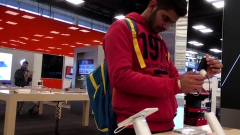 Motion of people playing iphone at store with 4k resolution Video stock 71381034