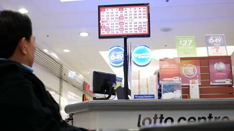 The motion of people playing keno game inside mall lottery ticket retailer Video stock 203443690