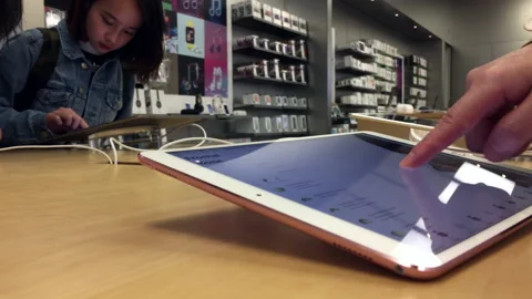 Motion of people playing new ipad pro inside Apple store with 4k resolution. Stock Footage 94426639