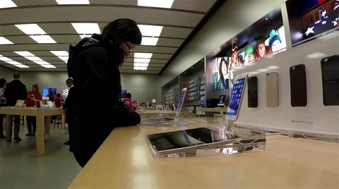 Motion of people playing new iphone inside Apple store Stock Footage 48557518