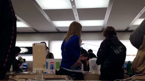 Motion of people playing new iphone inside Apple store Stock Footage 48590902