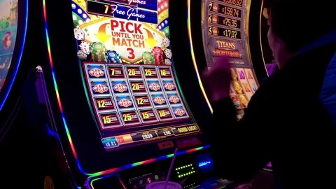 Motion of people playing slot machine and win big price inside Hard Rock Casino Stock Footage 71611121