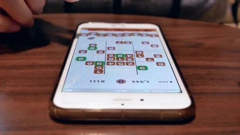 Motion of people playing sudoku game while waiting their food Stock Footage 82707873