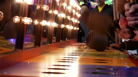 Motion of people playing whack game at the West Coast Amusements Carnival Stock Footage 74290916