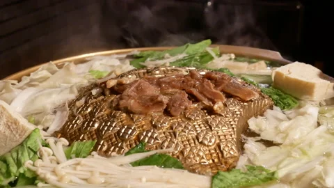 Motion of people putting meat while hot pot boiling inside Chinese restaurant Video stock 97154363