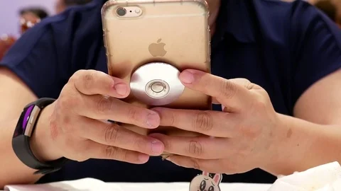 Motion of people reading message on iphone inside Chinese restaurant Video stock 79093023