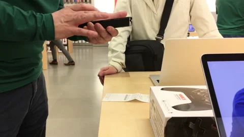 Motion of people returning gamepad inside Apple store Stock Footage 89452479
